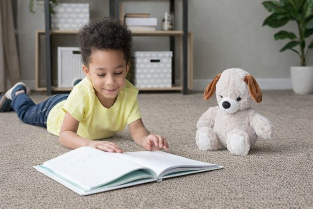 Child reading on carpet in Plymouth County home - comfortable wool carpeting from Weston Carpet & Rugs Norwell MA showroom