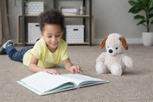 Child reading on carpet in Plymouth County home - comfortable wool carpeting from Weston Carpet & Rugs Norwell MA showroom