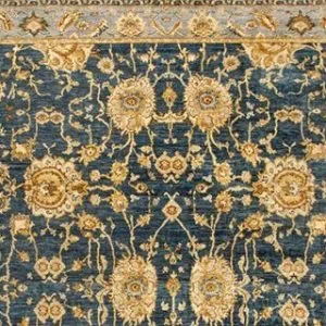 A close-up of a Couristan Easton Adaline area rug in navy and cream, featuring a detailed, traditional floral pattern with large, ornate cream-colored blossoms and intricate foliage on a dark navy background